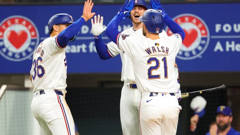 Mar 30, 2024; Arlington, Texas, USA; Texas Rangers first baseman Jared Walsh (21) celebrates with Texas Rangers designated hitter Wyatt Langford (36) and Texas Rangers catcher Jonah Heim (28) after hitting a two-run home run during the second inning against the Chicago Cubs at Globe Life Field. Mandatory Credit: Kevin Jairaj-USA TODAY Sports