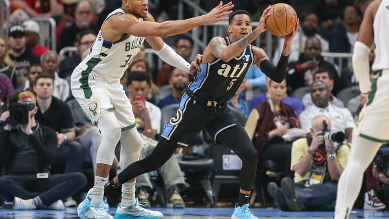 Mar 30, 2024; Atlanta, Georgia, USA; Milwaukee Bucks forward Giannis Antetokounmpo (34) defends Atlanta Hawks guard Dejounte Murray (5) in the first quarter at State Farm Arena. Mandatory Credit: Brett Davis-USA TODAY Sports