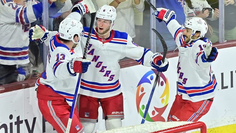 Mar 30, 2024; Tempe, Arizona, USA; New York Rangers defenseman Zac Jones (6) celebrates with left wing Alexis Lafreniere (13) and center Vincent Trocheck (16) after scoring a goal in the third period against the Arizona Coyotes at Mullett Arena. Mandatory Credit: Matt Kartozian-USA TODAY Sports