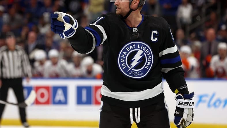Mar 30, 2024; Tampa, Florida, USA; Tampa Bay Lightning center Steven Stamkos (91) points against the New York Islanders during the first period at Amalie Arena. Mandatory Credit: Kim Klement Neitzel-USA TODAY Sports