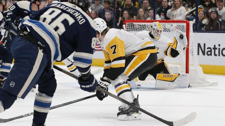 Mar 30, 2024; Columbus, Ohio, USA; Pittsburgh Penguins goalie Alex Nedeljkovic (39) makes a glove save on the shot attempt of Columbus Blue Jackets right wing Kirill Marchenko (86) during the first period at Nationwide Arena. Mandatory Credit: Russell LaBounty-USA TODAY Sports