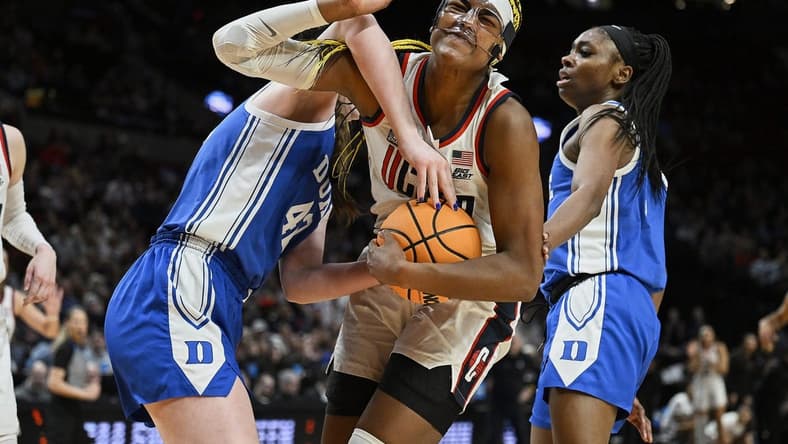 Mar 30, 2024; Portland, OR, USA; UConn Huskies forward Aaliyah Edwards (3) is fouled by Duke Blue Devils center Kennedy Brown (42) during the second half in the semifinals of the Portland Regional of the 2024 NCAA Tournament at the Moda Center. Mandatory Credit: Troy Wayrynen-USA TODAY Sports