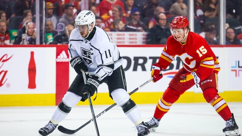 Mar 30, 2024; Calgary, Alberta, CAN; Los Angeles Kings center Anze Kopitar (11) controls the puck against the Calgary Flames during the third period at Scotiabank Saddledome. Mandatory Credit: Sergei Belski-USA TODAY Sports