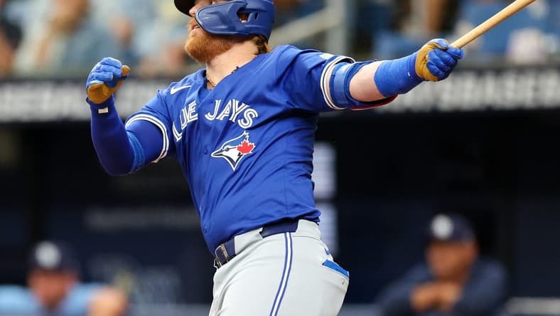 Mar 31, 2024; St. Petersburg, Florida, USA; Toronto Blue Jays third baseman Justin Turner (2) hits a solo home run against the Tampa Bay Rays in the fifth inning at Tropicana Field. Mandatory Credit: Nathan Ray Seebeck-USA TODAY Sports