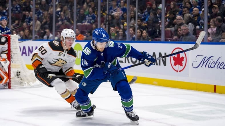 Mar 31, 2024; Vancouver, British Columbia, CAN; Anaheim Ducks defenseman Jackson LaCombe (60) defends against Vancouver Canucks forward Pius Suter (24) in the first period at Rogers Arena. Mandatory Credit: Bob Frid-USA TODAY Sports