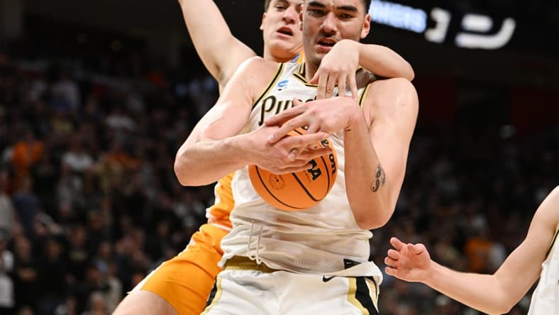 Mar 31, 2024; Detroit, MI, USA; Purdue Boilermakers center Zach Edey (15) controls the ball defended by Tennessee Volunteers forward J.P. Estrella (13) in the second half during the NCAA Tournament Midwest Regional Championship- at Little Caesars Arena. Mandatory Credit: Lon Horwedel-USA TODAY Sports