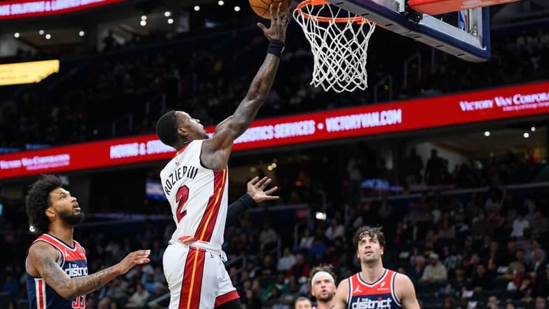 Mar 31, 2024; Washington, District of Columbia, USA; Miami Heat guard Terry Rozier (2) shoots a layup over Washington Wizards forward Marvin Bagley III (35) during the first quarter at Capital One Arena. Mandatory Credit: Reggie Hildred-USA TODAY Sports