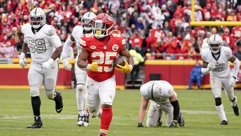 Dec 25, 2023; Kansas City, Missouri, USA; Kansas City Chiefs running back Clyde Edwards-Helaire (25) runs the ball against the Las Vegas Raiders during the game at GEHA Field at Arrowhead Stadium. Mandatory Credit: Denny Medley-USA TODAY Sports