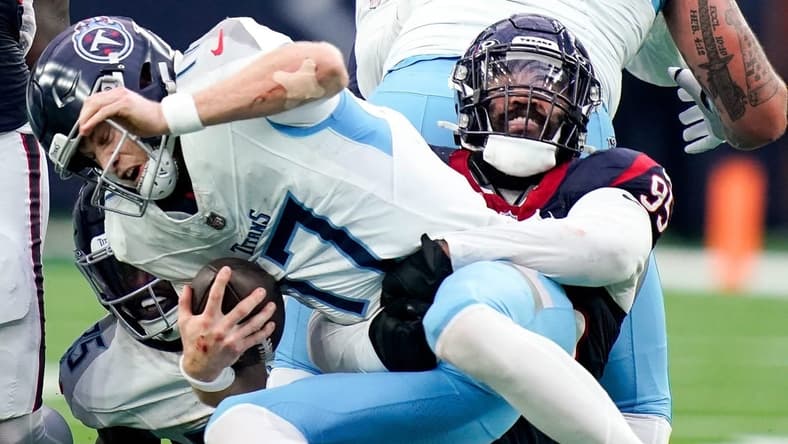 Tennessee Titans quarterback Ryan Tannehill (17) is sacked by Houston Texans defensive end Derek Barnett (95) on a fourth down during the fourth quarter at NRG Stadium in Houston, Texas., Sunday, Dec. 31, 2023.