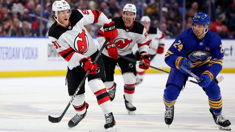 Mar 29, 2024; Buffalo, New York, USA; Buffalo Sabres center Dylan Cozens (24) watches as New Jersey Devils center Dawson Mercer (91) makes a pass during the third period at KeyBank Center. Mandatory Credit: Timothy T. Ludwig-USA TODAY Sports