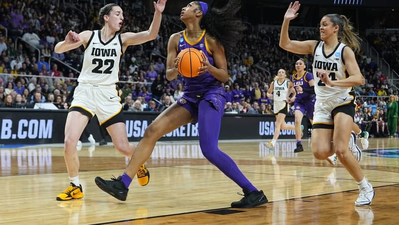 Apr 1, 2024; Albany, NY, USA; LSU Lady Tigers forward Angel Reese (10) controls the ball against Iowa Hawkeyes guard Caitlin Clark (22) and guard Gabbie Marshall (24) in the first half in the finals of the Albany Regional in the 2024 NCAA Tournament at MVP Arena. Mandatory Credit: Gregory Fisher-USA TODAY Sports