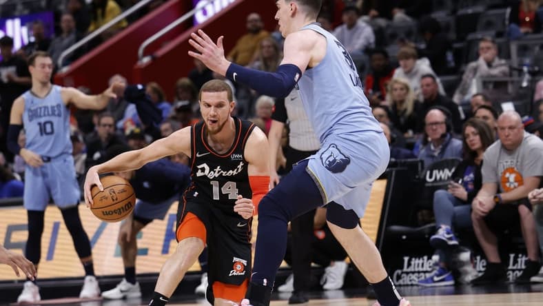 Apr 1, 2024; Detroit, Michigan, USA;  d14 dribbles defended by Memphis Grizzlies forward Jake LaRavia (3) in the first half at Little Caesars Arena. Mandatory Credit: Rick Osentoski-USA TODAY Sports