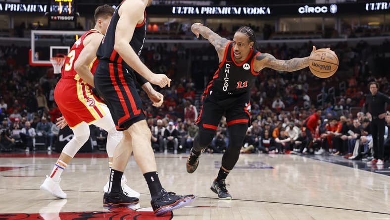 Apr 1, 2024; Chicago, Illinois, USA; Chicago Bulls forward DeMar DeRozan (11) tries to control the ball against the Atlanta Hawks during the first half at United Center. Mandatory Credit: Kamil Krzaczynski-USA TODAY Sports