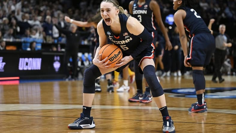 UConn Huskies guard Paige Bueckers (5) celebrates after beating the USC Trojans in the finals of the Portland Regional of the NCAA Tournament at the Moda Center. Mandatory Credit: Troy Wayrynen-USA TODAY Sports