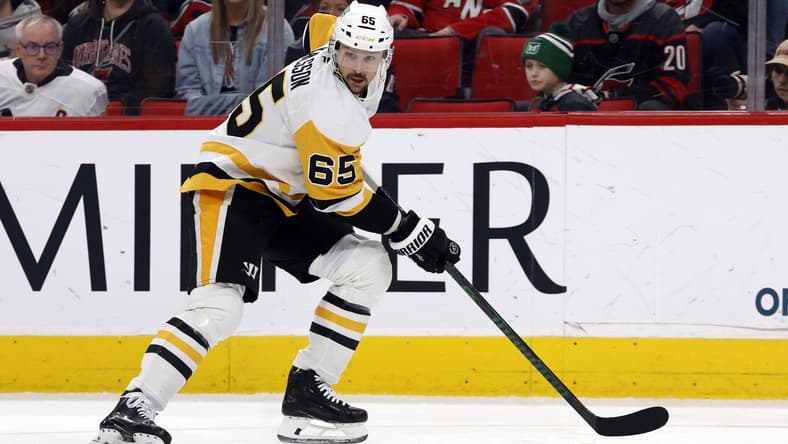 Pittsburgh Penguins' Erik Karlsson (65) moves the puck against the Carolina Hurricanes during the second period of an NHL hockey game in Raleigh, N.C., Sunday, Jan. 5, 2025. (AP Photo/Karl DeBlaker)