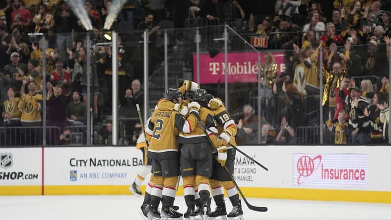 Vegas Golden Knights celebrate after Vegas Golden Knights defenseman Noah Hanifin scored against the Nashville Predators during the third period of an NHL hockey game Saturday, April 12, 2025, in Las Vegas. (AP Photo/John Locher)