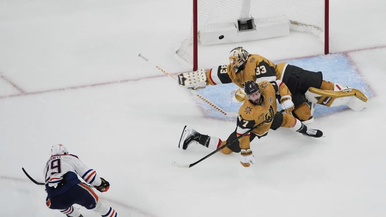 Edmonton Oilers center Leon Draisaitl (29) scores against Vegas Golden Knights goaltender Adin Hill (33) during overtime of Game 2 of a second-round NHL hockey playoff series Thursday, May 8, 2025, in Las Vegas. (AP Photo/John Locher)
