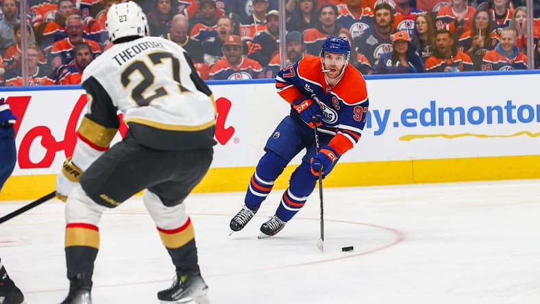EDMONTON, AB - MAY 12: Las Vegas Golden Knights Defenceman Shea Theodore (27) stops Edmonton Oilers Center Connor McDavid (97) in the first period of the Stanley Cup Playoffs Second Round Edmonton Oilers game versus the Las Vegas Golden Knights on May 12, 2025 at Rogers Place in Edmonton, AB. (Photo by Curtis Comeau/Icon Sportswear)