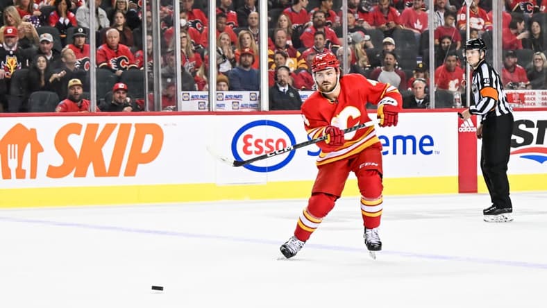CALGARY, AB - OCTOBER 18: Calgary Flames Defenceman Rasmus Andersson (4) passes the puck during the second period of an NHL game between the Calgary Flames and the Vegas Golden Knights on October 18, 2022, at the Scotiabank Saddledome in Calgary, AB. (Photo by Brett Holmes/Icon Sportswire)