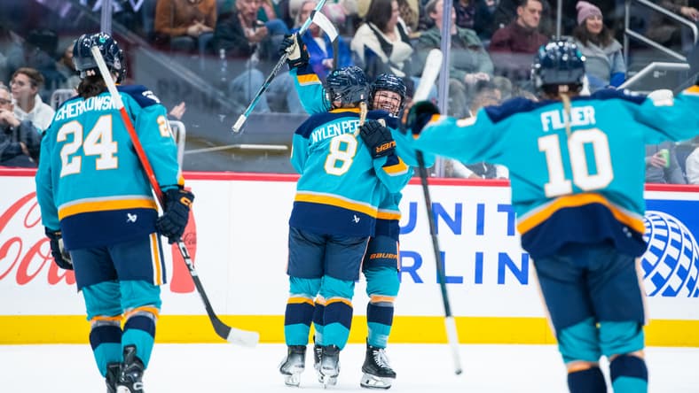 New York Sirens forwards Sarah Fillier, Paetyn Levis, and Anne Cherkowski celebrate with Maja Nylen Persson during a 2-1 win over the Montreal Victoire.