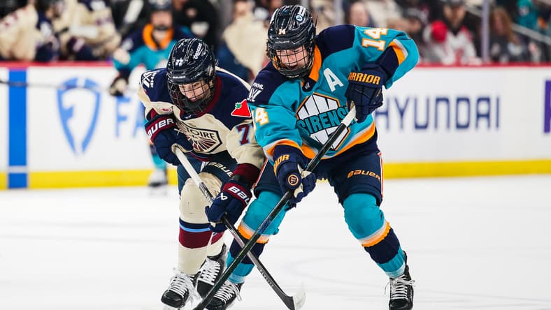 New York Sirens defender Jaime Bourbonnais and Montreal Victoire forward Jade Downie-Landry battle for the puck.