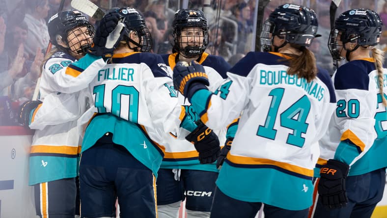 New York Sirens first-liners Casey O'Brien, Sarah Fillier, and Anne Cherkowski celebrate after all factoring into a goal against the Montreal Victoire.