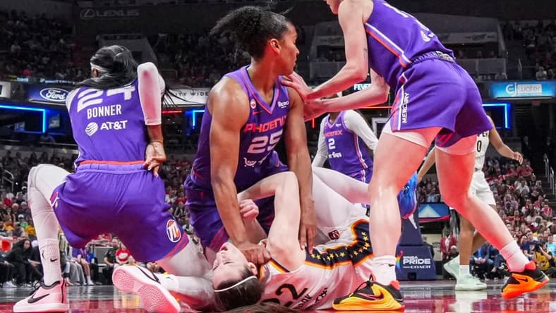 Phoenix Mercury forward Alyssa Thomas (25) scrambles to get up over Indiana Fever guard Caitlin Clark (22) on Wednesday, June