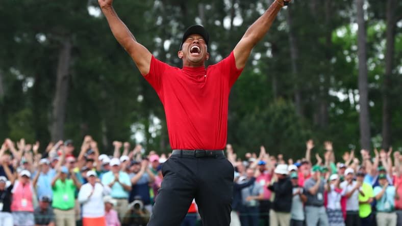 Tiger Woods celebrates after making a putt on the 18th green to win The Masters golf tournament at Augusta National Golf Club on