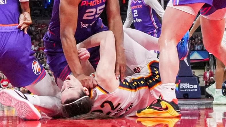 Phoenix Mercury forward Alyssa Thomas (25) scrambles to get up over Indiana Fever guard Caitlin Clark (22) on Wednesday, June