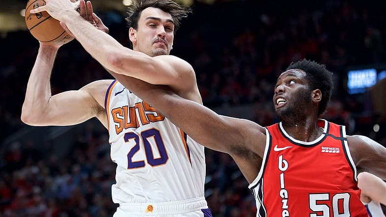 Mar 10, 2020; Portland, OR, USA; Phoenix Suns forward Dario Saric (20) and Portland Trail Blazers forward Caleb Swanigan (50) battle for a rebound during the second quarter at the Moda Center. Mandatory Credit: Craig Mitchelldyer-USA TODAY Sports