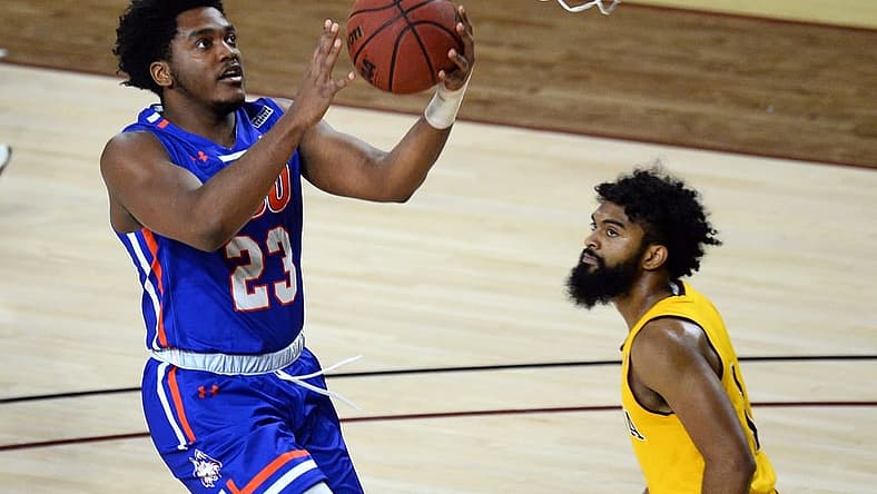 Nov 29, 2020; Tempe, Arizona, USA; Houston Baptist Huskies guard Darius Lee (23) puts up a layup against Arizona State Sun Devils guard Remy Martin (1) during the first half at Desert Financial Arena (Tempe). Mandatory Credit: Joe Camporeale-USA TODAY Sports