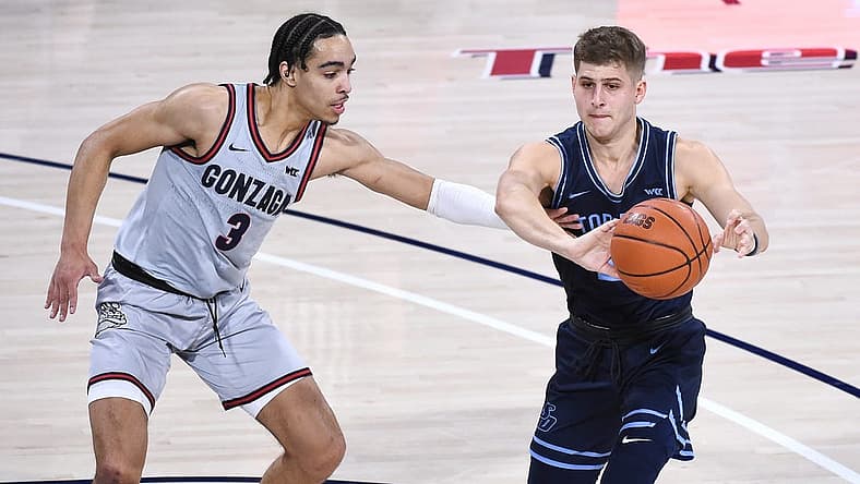 Feb 20, 2021; Spokane, Washington, USA; Gonzaga Bulldogs guard Andrew Nembhard (3) reaches for the ball against San Diego Toreros guard Joey Calcaterra (2) in the first half at McCarthey Athletic Center. Mandatory Credit: James Snook-USA TODAY Sports