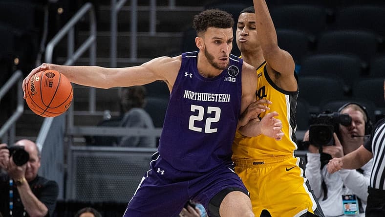 Mar 10, 2022; Indianapolis, IN, USA; Northwestern Wildcats forward Pete Nance (22) dribbles the ball while Iowa Hawkeyes forward Keegan Murray (15) defends in the first half at Gainbridge Fieldhouse. Mandatory Credit: Trevor Ruszkowski-USA TODAY Sports