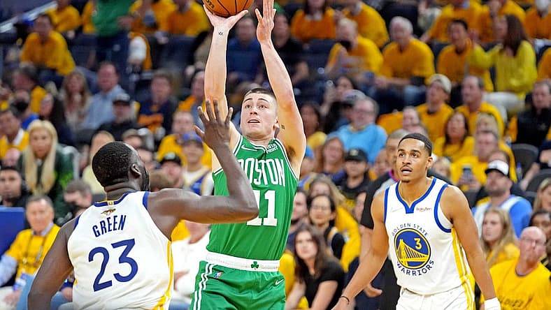 Jun 5, 2022; San Francisco, California, USA; Boston Celtics guard Payton Pritchard (11) shoots the ball against Golden State Warriors forward Draymond Green (23) during game two of the 2022 NBA Finals at Chase Center. Mandatory Credit: Kyle Terada-USA TODAY Sports