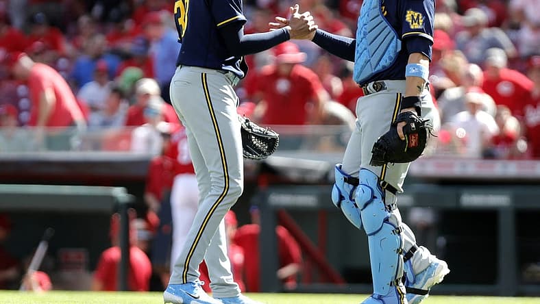 Jun 19, 2022; Cincinnati, Ohio, USA; Milwaukee Brewers closing pitcher Devin Williams (38) reacts with catcher Victor Caratini (7) after the Brewers defeated the Cincinnati Reds at Great American Ball Park. Mandatory Credit: David Kohl-USA TODAY Sports