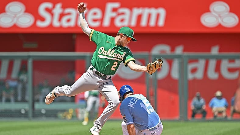 Jun 26, 2022; Kansas City, Missouri, USA;  Kansas City Royals second baseman Whit Merrifield (15) slides into second base, for a stolen base, under Oakland Athletics shortstop Nick Allen (2) during the third inning at Kauffman Stadium. Mandatory Credit: Peter Aiken-USA TODAY Sports
