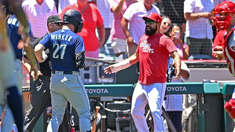 Jun 26, 2022; Anaheim, California, USA; Seattle Mariners right fielder Jesse Winker (27) engages with Los Angeles Angels Anthony Rendon (6) during a benches clearing brawl in the second inning at Angel Stadium. Mandatory Credit: Jayne Kamin-Oncea-USA TODAY Sports