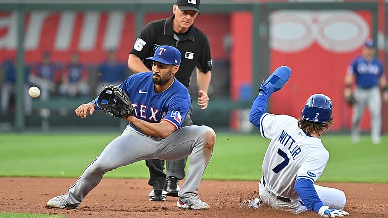 Jun 27, 2022; Kansas City, Missouri, USA; Kansas City Royals shortstop Bobby Witt Jr. (7) steals second against Texas Rangers second baseman Marcus Semien (2) during the first inning at Kauffman Stadium. Mandatory Credit: Peter Aiken-USA TODAY Sports