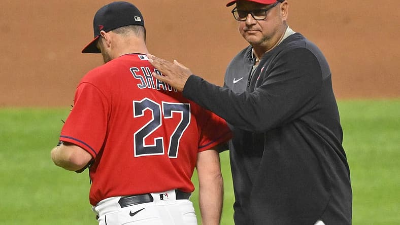 Jun 27, 2022; Cleveland, Ohio, USA; Cleveland Guardians relief pitcher Bryan Shaw (27) walks of the mound beside manager Terry Francona (77) during a pitching change in the seventh inning against the Minnesota Twins at Progressive Field. Mandatory Credit: David Richard-USA TODAY Sports