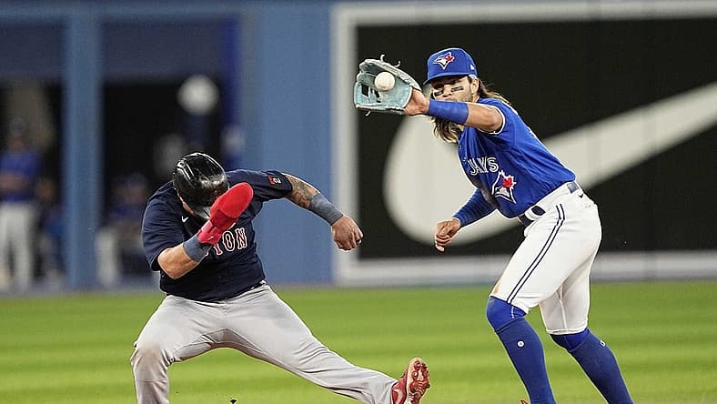 Jun 27, 2022; Toronto, Ontario, CAN; Boston Red Sox catcher Christian Vazquez (7) goes back to second against Toronto Blue Jays shortstop Bo Bichette (11) can make a tag during the seventh inning at Rogers Centre. Mandatory Credit: John E. Sokolowski-USA TODAY Sports