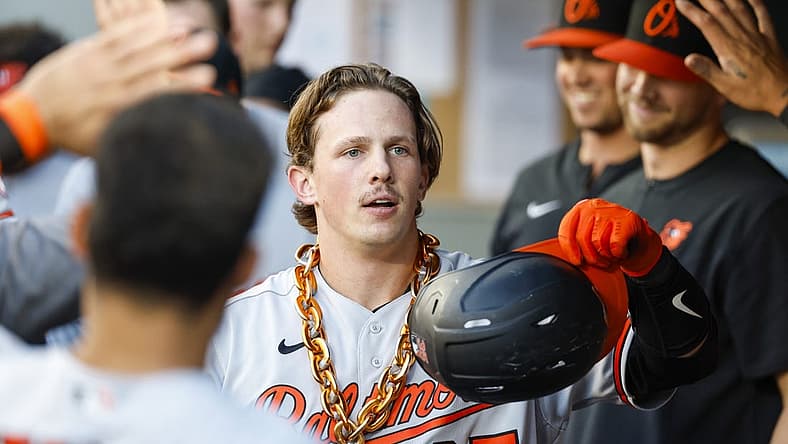 Jun 27, 2022; Seattle, Washington, USA; Baltimore Orioles catcher Adley Rutschman (35) celebrates in the dugout after hitting a solo-home run against the Seattle Mariners during the third inning at T-Mobile Park. Mandatory Credit: Joe Nicholson-USA TODAY Sports