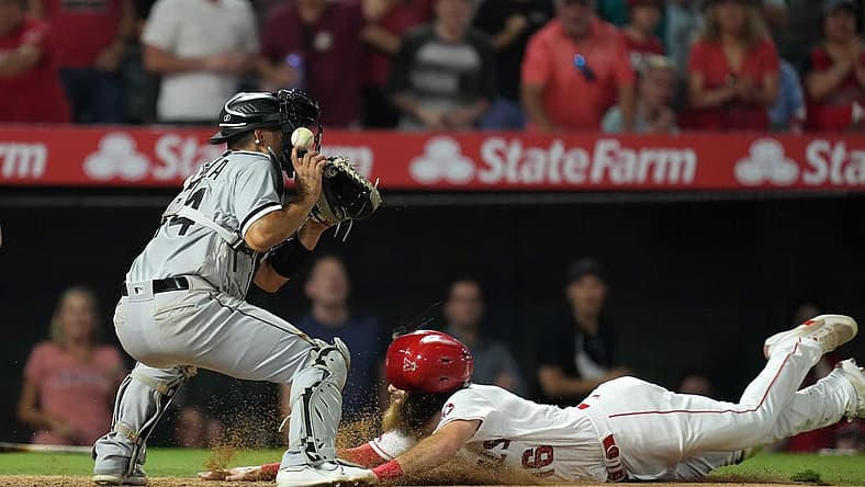 Jun 27, 2022; Anaheim, California, USA; Los Angeles Angels left fielder Brandon Marsh (16) slides into home plate to beat a throw to Chicago White Sox catcher Seby Zavala (44) in the seventh inning at Angel Stadium. Mandatory Credit: Kirby Lee-USA TODAY Sports