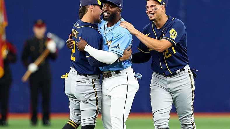 Jun 28, 2022; St. Petersburg, Florida, USA; Tampa Bay Rays left fielder Randy Arozarena (56) is greeted by Milwaukee Brewers shortstop Willy Adames (27) and shortstop Luis Urias (2) before a game at Tropicana Field. Mandatory Credit: Nathan Ray Seebeck-USA TODAY Sports