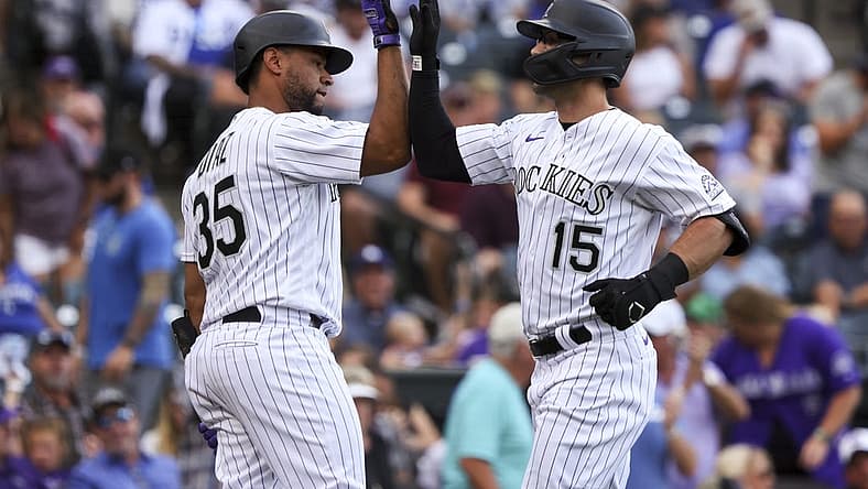 Jun 28, 2022; Denver, Colorado, USA; Colorado Rockies center fielder Randal Grichuk (15) high fives catcher Elias Diaz (35) after hitting a home run against the Los Angeles Dodgers during the second inning at Coors Field. Mandatory Credit: Michael Ciaglo-USA TODAY Sports