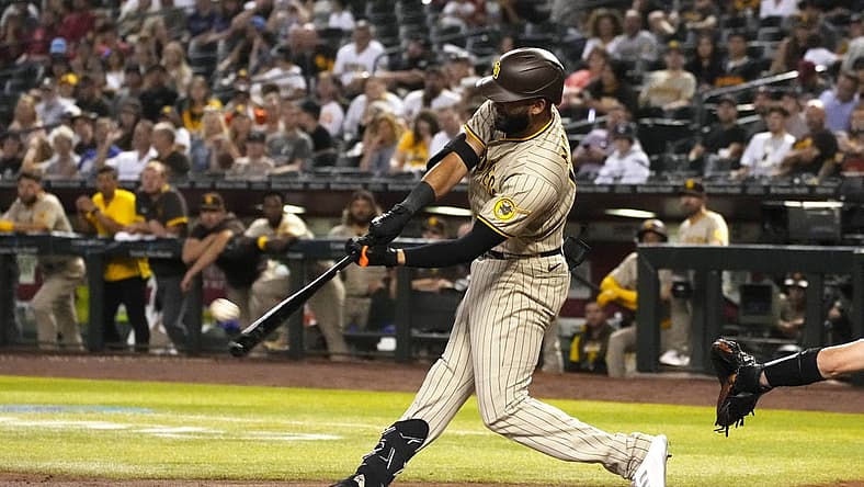 Jun 28, 2022; Phoenix, Arizona, USA; San Diego Padres right fielder Nomar Mazara (16) hits a two run homerun against the Arizona Diamondbacks in the fourth inning at Chase Field. Mandatory Credit: Rick Scuteri-USA TODAY Sports