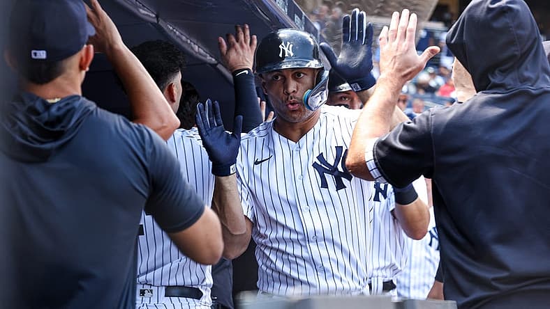 Jun 29, 2022; Bronx, New York, USA;New York Yankees designated hitter Giancarlo Stanton (27) celebrates with teammates after hitting a three run home run during the third inning against the Oakland Athletics at Yankee Stadium. Mandatory Credit: Vincent Carchietta-USA TODAY Sports