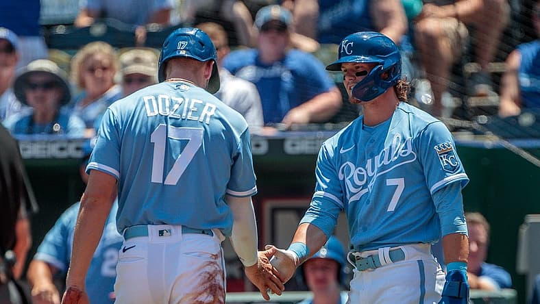 Jun 29, 2022; Kansas City, Missouri, USA; Kansas City Royals shortstop Bobby Witt Jr. (7) slaps hands with Kansas City Royals first baseman Hunter Dozier (17) after scoring during the first inning against the Texas Rangers at Kauffman Stadium. Mandatory Credit: William Purnell-USA TODAY Sports