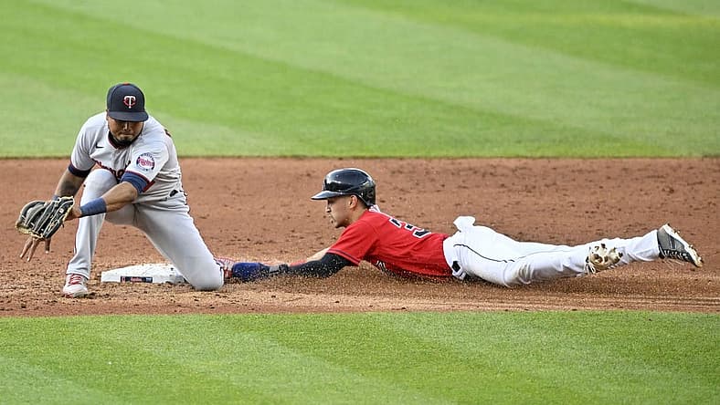 Jun 29, 2022; Cleveland, Ohio, USA; Cleveland Guardians left fielder Steven Kwan (38) steals second base beside Minnesota Twins shortstop Jorge Polanco (11) in the third inning at Progressive Field. Mandatory Credit: David Richard-USA TODAY Sports