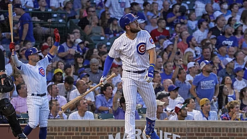 Jun 30, 2022; Chicago, Illinois, USA; Chicago Cubs third baseman Patrick Wisdom (16) watches his grand slam home run against the Cincinnati Reds during the second inning at Wrigley Field. Mandatory Credit: David Banks-USA TODAY Sports