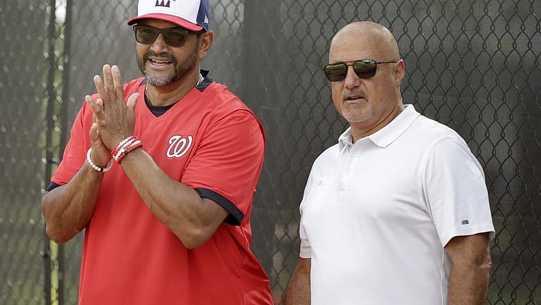 Feb 13, 2020; West Palm Beach, Florida, USA; Washington Nationals manager Dave Martinez (4) and general manager Mike Rizzo watch the pitchers warm up during a spring training workout at FITTEAM Ballpark. Mandatory Credit: Rhona Wise-USA TODAY Sports